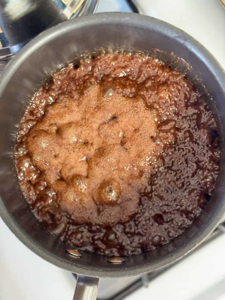 Chocolate mixture boiling in pot.