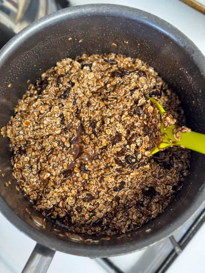 Oats and raisins stirred into chocolate mixture in large pot.