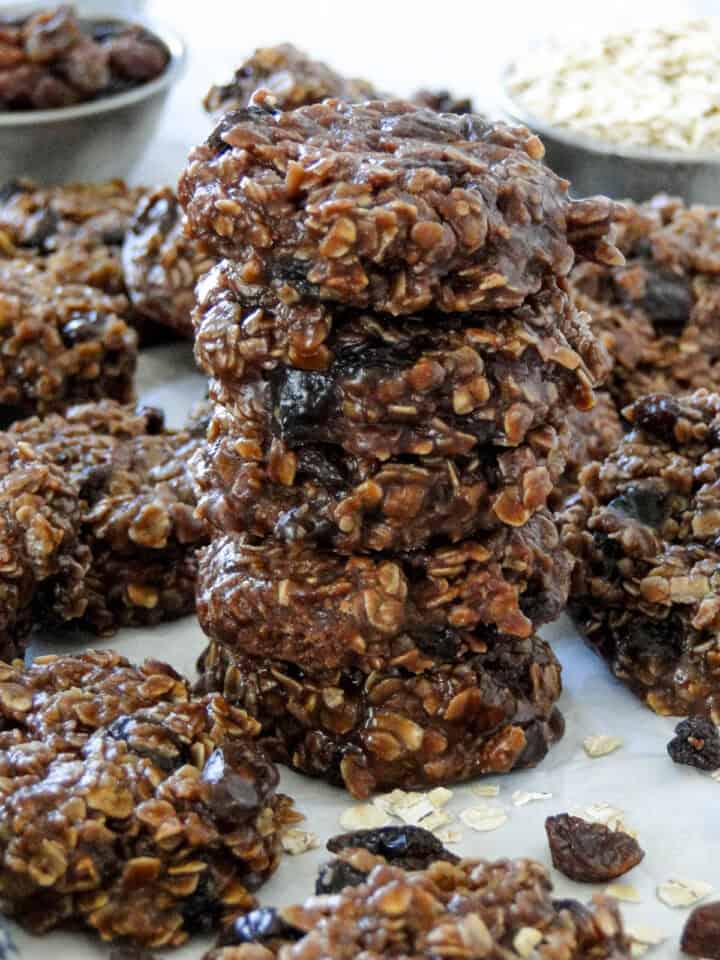 Close up side view of five no bake chocolate cookies stacked.