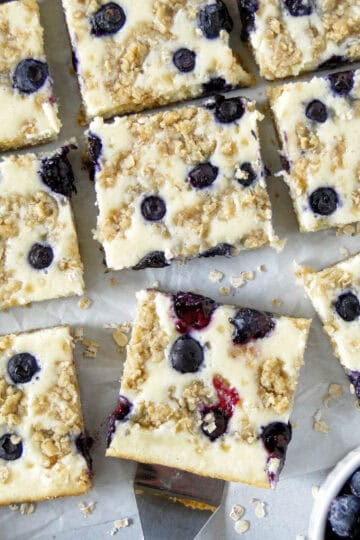 Close up top view of blueberry cream cheese bars sliced and spatula under one bar.