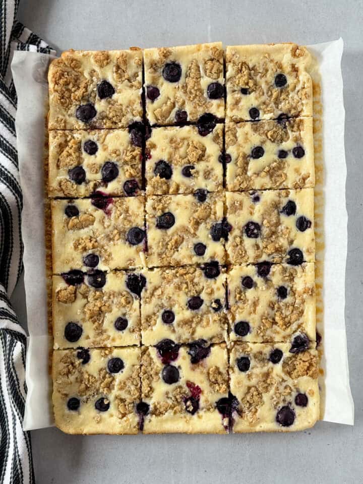 Baked and sliced cream cheese bars.