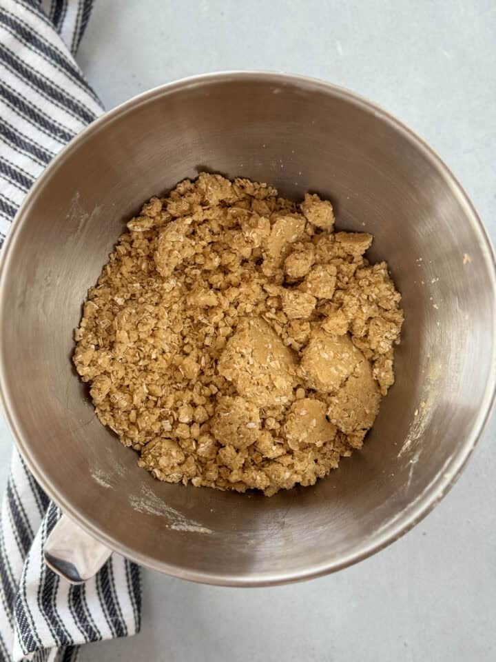 Oat mixture crust and topping mixed together in large metal mixing bowl.