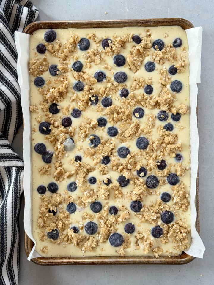 Blueberries and remaining oat mixture added on top of cream cheese filling in 9x13 pan.