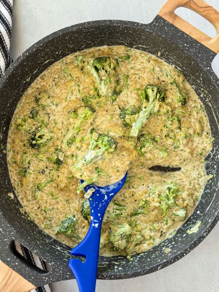 Broccoli cooked in skillet and cream added to skillet.
