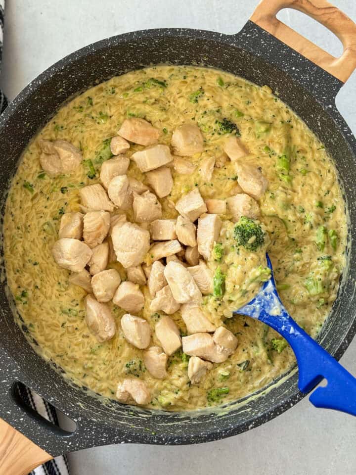 Cheese stirred into pasta and chicken added back into skillet.