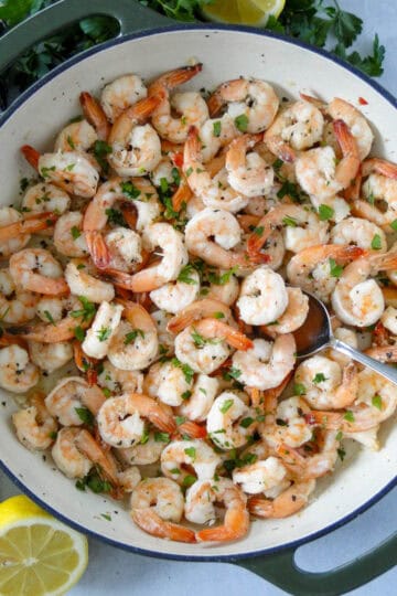 Top view of garlic butter shrimp in skillet.