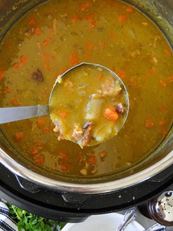 Instant pot split pea soup being ladled out of instant pot.