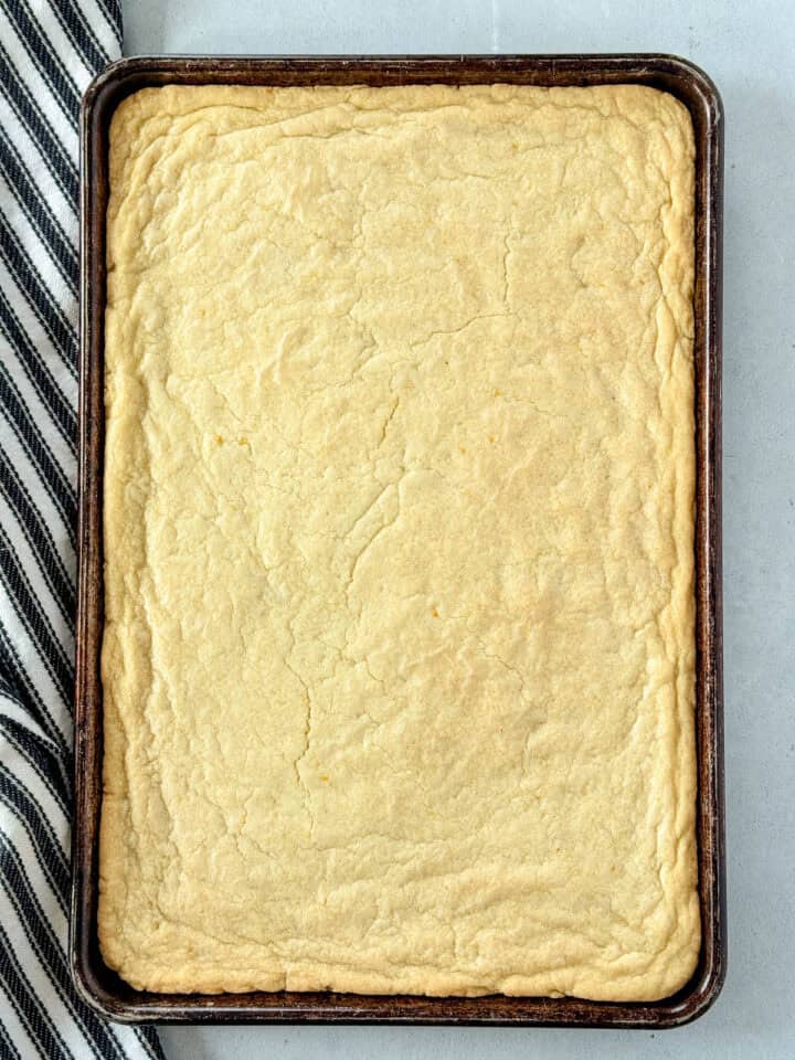 Baked lemon cookie bars in sheet pan.