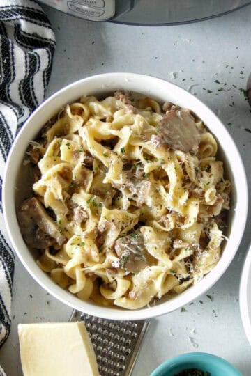 Top view of instant pot ground beef stroganoff in white round bowl.