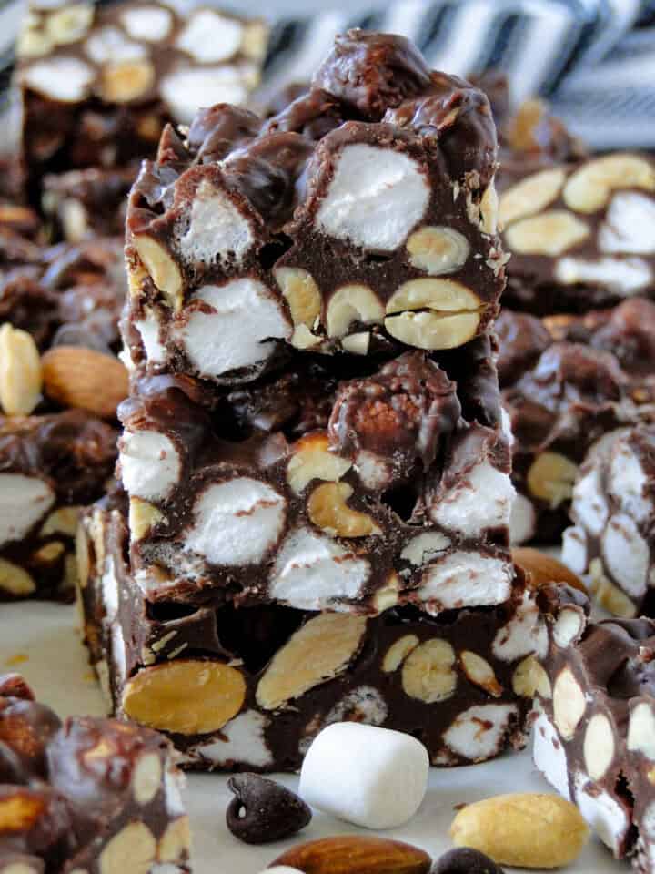 Side view of no bake rocky road bars sliced and three stacked showing off the center of the bars.