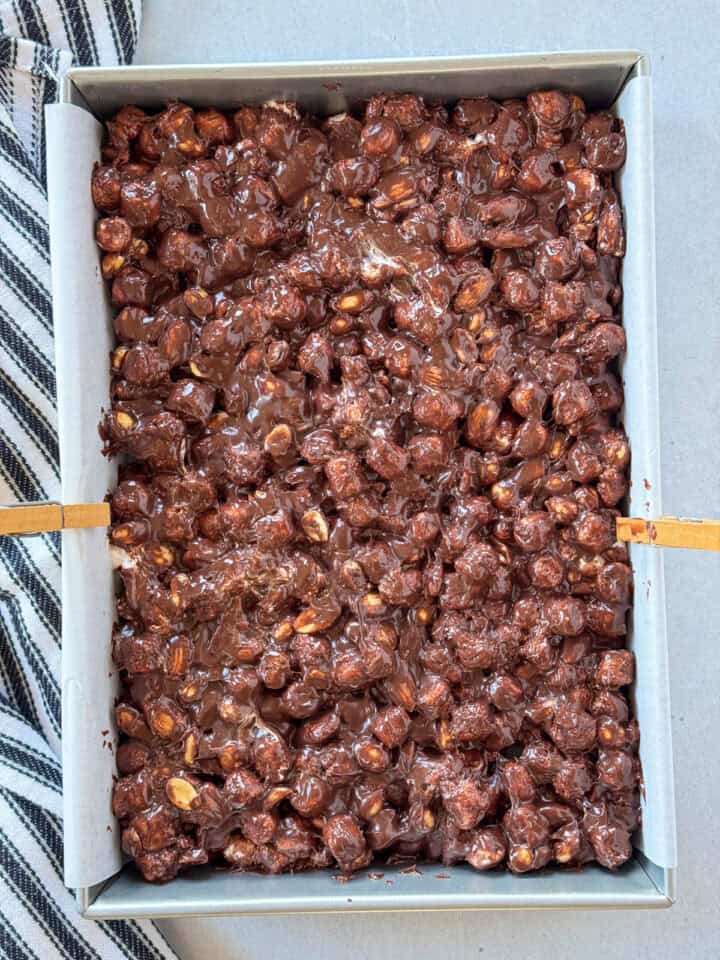 Rocky road bars mixture patted into parchment lined 9x13 pan.