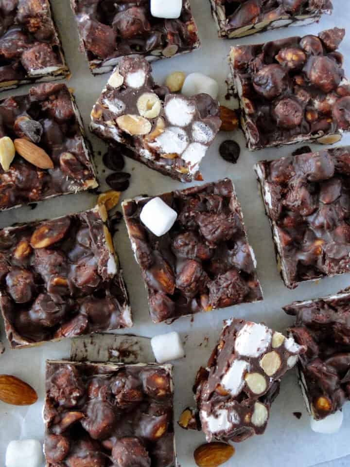 Top view of sliced no bake rocky road bars with 2 bars sitting on their side showing center of bars.