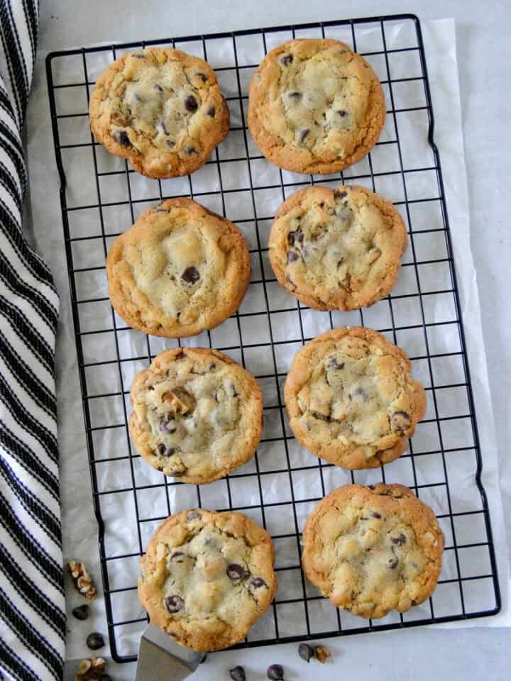 Jumbo chocolate chip cookies on wire cooling rack.