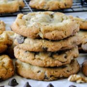 Side view of four jumbo chocolate chip cookies stacked.