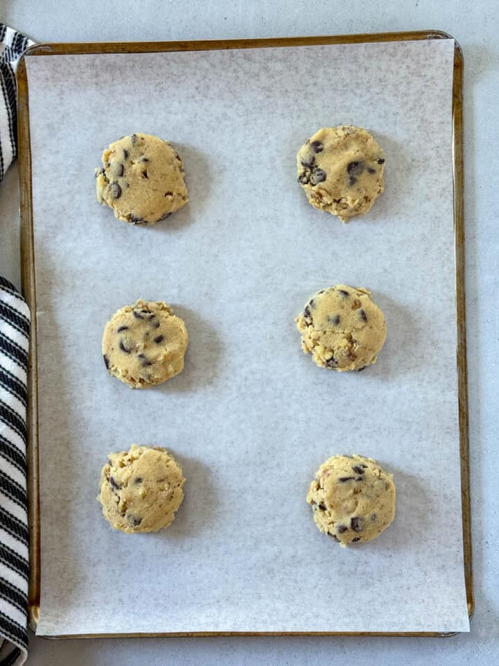 Flattened cookie dough on parchment lined cookie sheet.