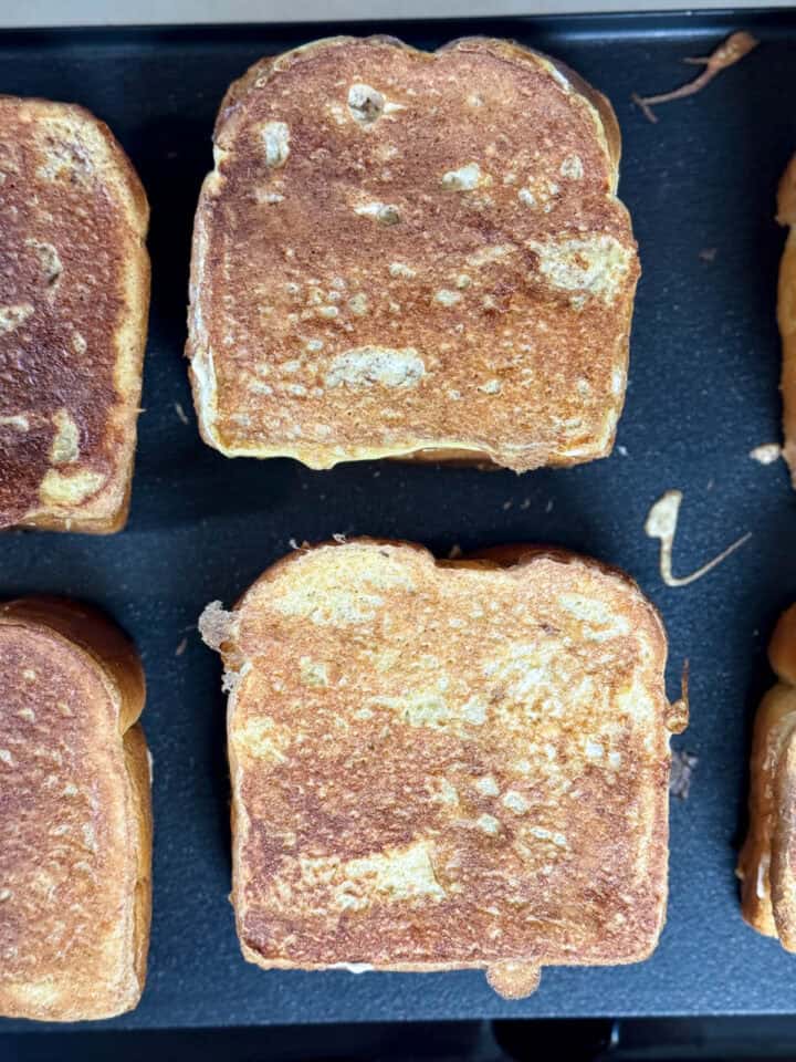 Stuffed french toast being cooked on griddle.
