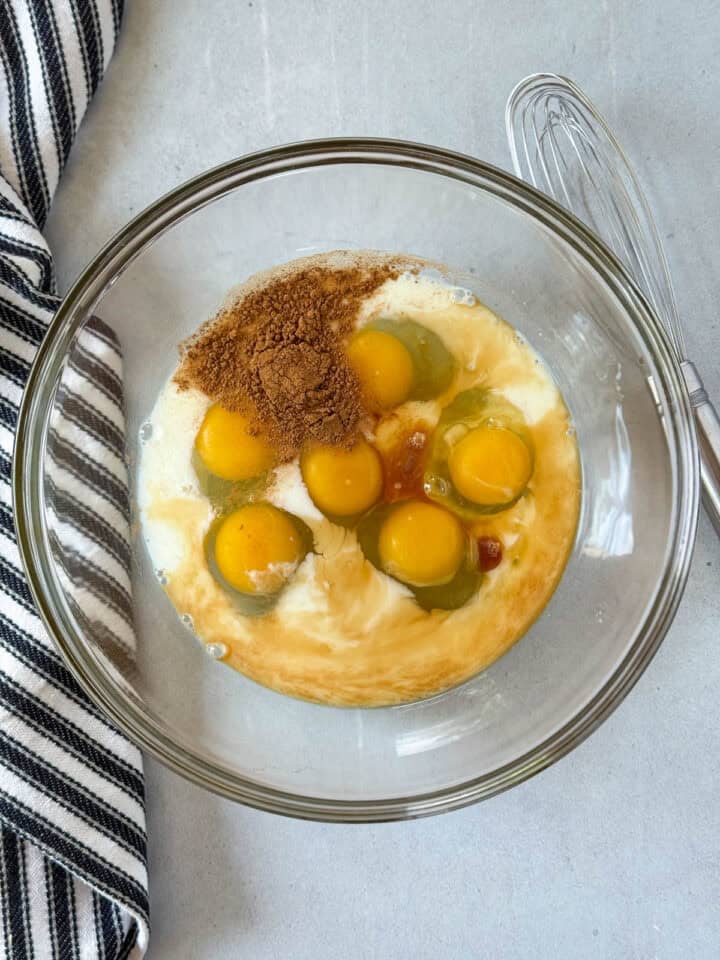 Egg custard ingredients in large glass mixing bowl.