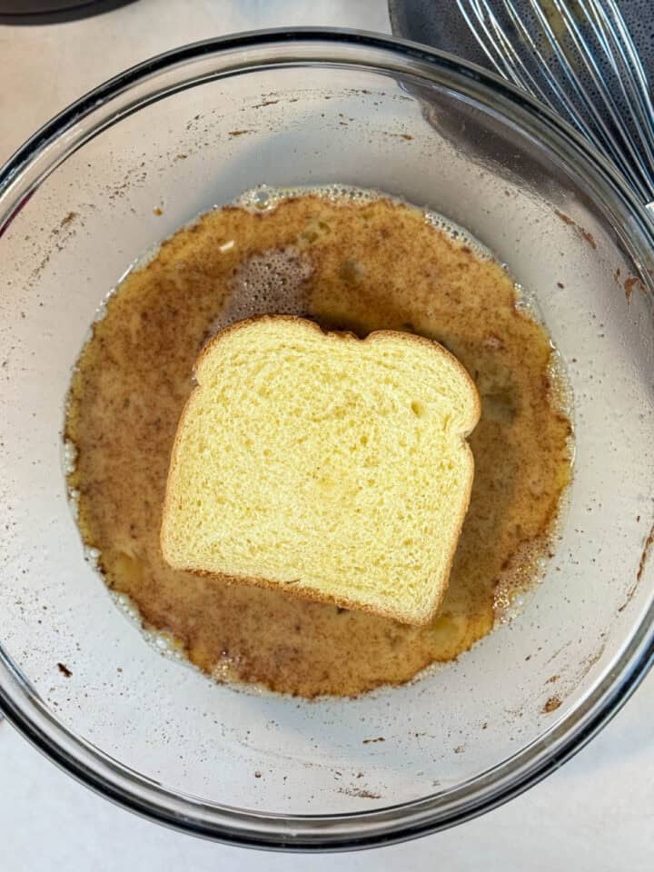 Once serving of stuffed french toast in bowl of egg custard.